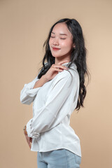 Fototapeta premium Indonesian Woman Smiling with Eyes Closed in a Calm, Graceful Pose