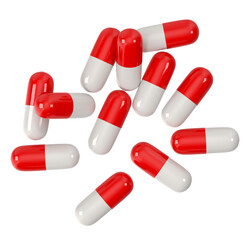 Red and white capsules scattered on a white background, close-up shot