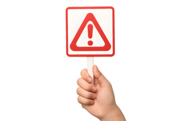 A hand holding a red warning sign for the concept of danger and caution.