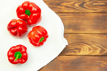red bell pepper on a white towel on the table. Bulgarian juicy pepper on a light texture