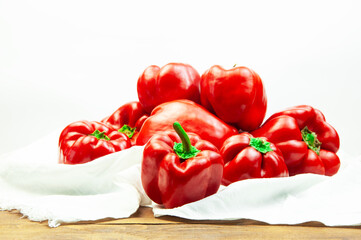 red bell pepper on a white towel on the table. Bulgarian juicy pepper on a light texture