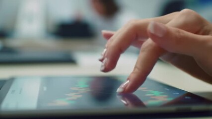 Professional woman analyzing stock market data on her tablet device for financial gain investment - Powered by Adobe