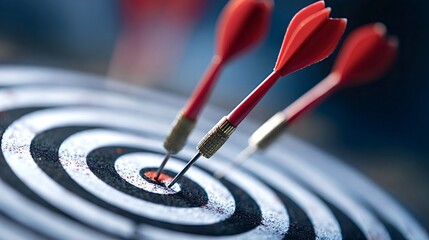 Red darts hitting bullseye on a black and white target board, illustrating concepts of precision, accuracy, goal achievement, success, business strategy, and effective marketing