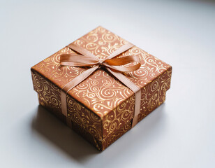 A neatly wrapped gift box with patterned paper and ribbon placed on a smooth surface