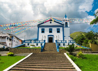 Historic Coastal Chapel with White Fa&ccedil;ade and Blue Doors in Ilhabela, Brazil