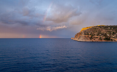 Golden sunset light illuminates Alanya Castle and the ancient fortress walls above the Mediterranean Sea in Alanya Turkey, showcasing historic architecture and scenic coastal beauty