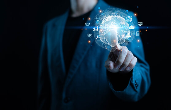 A businessman touching a glowing digital globe with global network icons, symbolizing worldwide connectivity digital transformation, data technology, smart solutions, and international business.