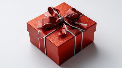 Obraz premium Sparkling red square package tied with a shiny bow sits on a white surface