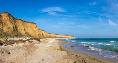 Landscape with the wild beach with a cliff from 23 August, Constanta County - Romania. Steep, yellowish cliffs and turquoise sea waters