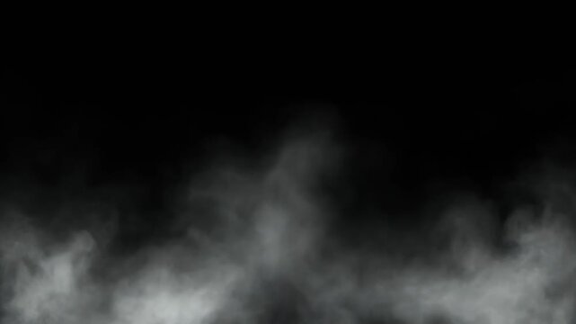 Dense fog drifting across a dark black background, creating a mysterious, atmospheric effect with low visibility and abstract formations