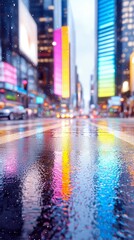 Obraz premium A low-angle view of a wet city street at night, with reflections of colorful neon signs and billboards on the slick pavement. Snowflakes are falling, adding a m
