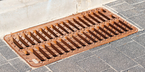 Metal Storm Drain Grate on Asphalt Road