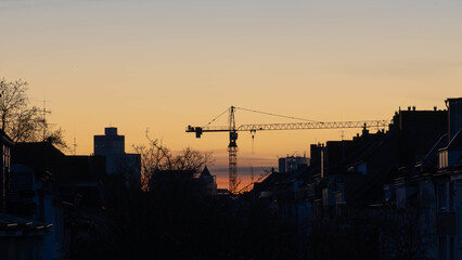 Crane in a fiery Sunset of Duesseldorf Germany in November 2025 - City Developement in the old Steel City of Germany. High quality photo