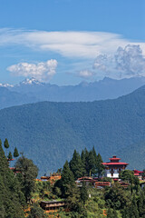 A monastery and small vaille on the highs over Punakha, and Himlayas peaks in the background
