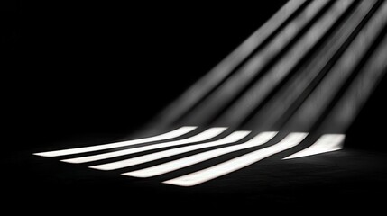Parallel beams of light cast dramatic stripes across a dark, textured floor, creating a stark contrast between light and shadow. The light source is angled from
