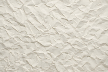 Obraz premium Beige crumpled paper full of texture and folds