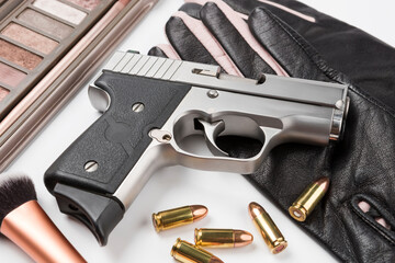 Automatic hand gun and ammunition on white background