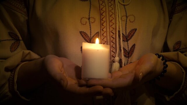 Ukraine 1932 - 1933. A candle is lit in the hands of a Ukrainian girl