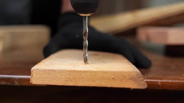 Drill Tool Making Hole in Wooden Board Close-Up. 4k footage