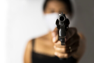 Close up of barrel revolver gun in her hand , Pointed at you