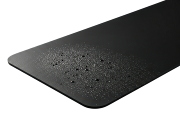 Black waterproof desk mat with water droplets on the surface on a transparent background