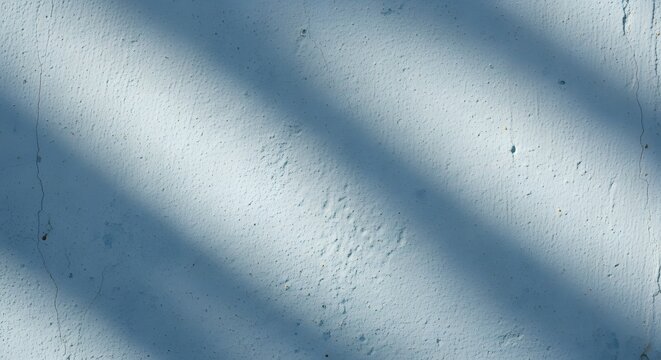 Light blue textured wall with diagonal shadows abstract backdrop