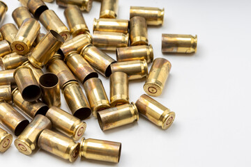 A pile of .45 bullet shells on white background