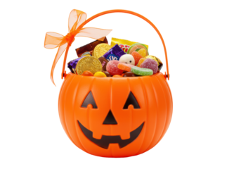 Vibrant orange pumpkin-shaped plastic basket with jack-o'-lantern face, overflowing with Halloween candies, orange ribbon, on transparent. Concept of festive Halloween celebration