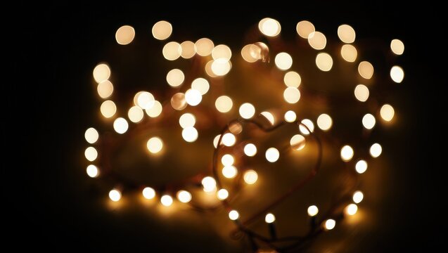 Heart shape made of warm glowing fairy lights bokeh