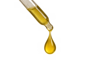 Dropper releasing a yellow-golden liquid drop, showing cosmetic serum, oil, or chemical substance. Transparent background