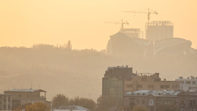 Yerevan city skyline in smoggy autumn sunset