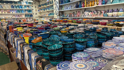 olorful ceramic bowls displayed in vibrant market with intricate designs