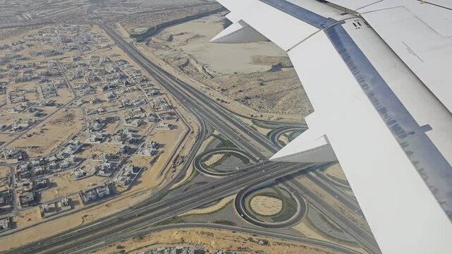 Plane landing in Dubai. Flying over desert in United Arab Emirates, Dubai view from a plane window. 4K video footage