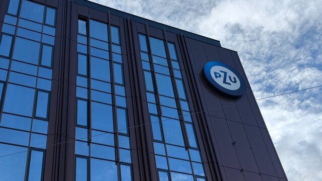 Wroclaw, Poland - October 24, 2025: PZU building exterior with logo against cloudy sky in urban setting