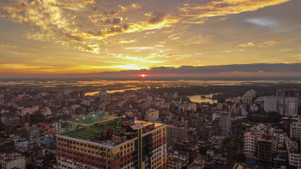 Aerial view of urban sunset with a rooftop football turf.