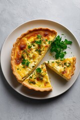 Freshly baked quiche with herbs on a plate