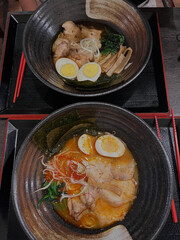 Dual Ramen Bowls Warm Evening Crowd.