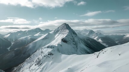Stunning snow covered mountain peaks against blue sky beckon adventure seekers