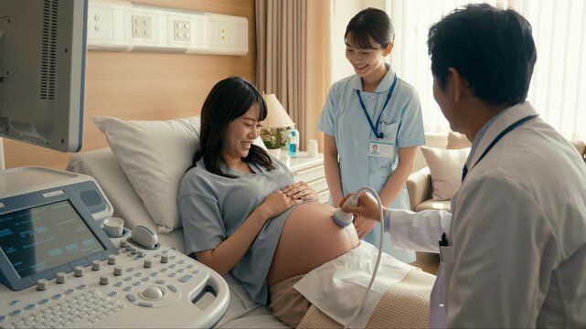Pregnant woman getting ultrasound checkup from male doctor and nurse