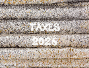 Taxes 2026 new year symbol. Concept words Taxes 2026 on beautiful grey mountain wall. Beautiful grey mountain wall background. Business and taxes 2026 new year concept. Copy space.