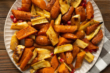Top view of roasted carrots and parsnips on plate