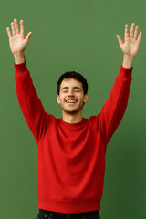 A cheerful man raises his arms with eyes closed. He wears a red sweatshirt and smiles broadly. AI generated