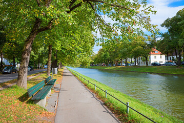 walkway with benches along canal Nymphenburg, autumn in munich