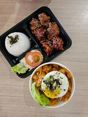 Flavorful portions served neatly inside divided container.