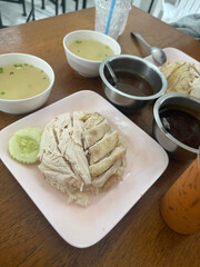 Steamed chicken rice paired with flavorful dipping sauces.