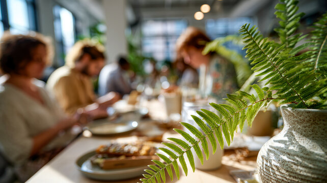 Friends gathering at a sunlit table for brunch, sharing food and conversation in a cozy, plant-filled cafe setting.