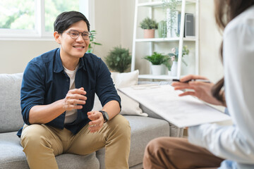 Psychology, depression. smile asian young male, man patient mental sitting on couch, explained...