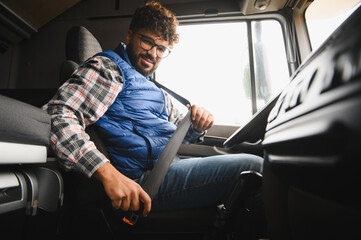 Truck driver fastening seat belt for road safety journey