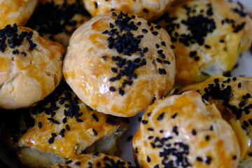 Delicious homemade black cumin and cheese pastries. Cactus ivy in the background. Parsley and cheese breakfast pastries. Ramadan iftar menu. Traditional Turkish pastries.