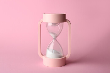 Crystal hourglass on pink background © Pixel-Shot